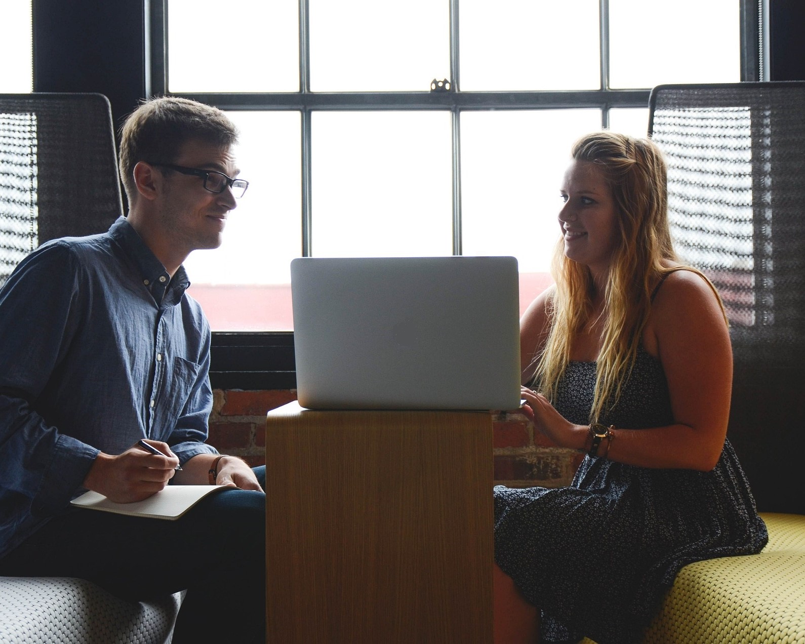Man and women looking at a laptop